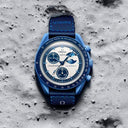 Blue chronograph men's watch with moon phase dial on textured gray surface